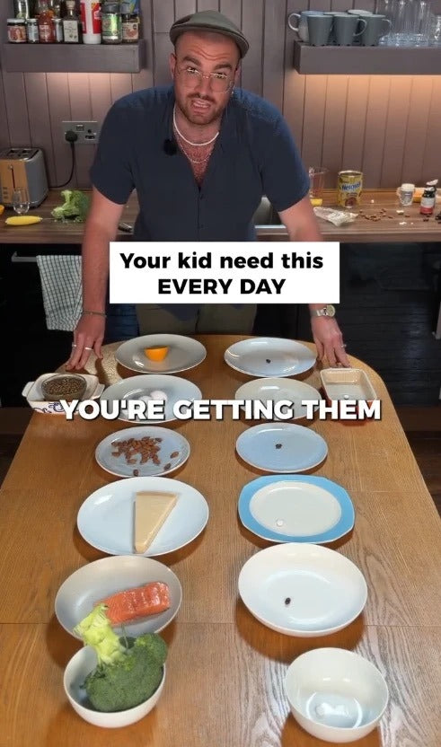 Still from a Bonjour ad: a presenter at a kitchen table laying out the foods a child needs every day